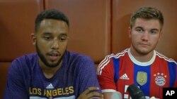 In this image made from TV, Anthony Sadler, a senior at Sacramento State University, left, sits with Alek Skarlatos, U.S. National Guardsman from Roseburg, Oregon, who both helped overpower high-speed train attacker, talk to the media early Saturday Aug. 22
