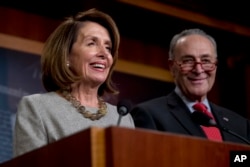 House Speaker Nancy Pelosi of Calif., and Senate Minority Leader Sen. Chuck Schumer of N.Y., smile during a news conference on Capitol Hill in Washington, Friday, Jan. 25, 2019, after President Donald Trump announces a deal to reopen the government.