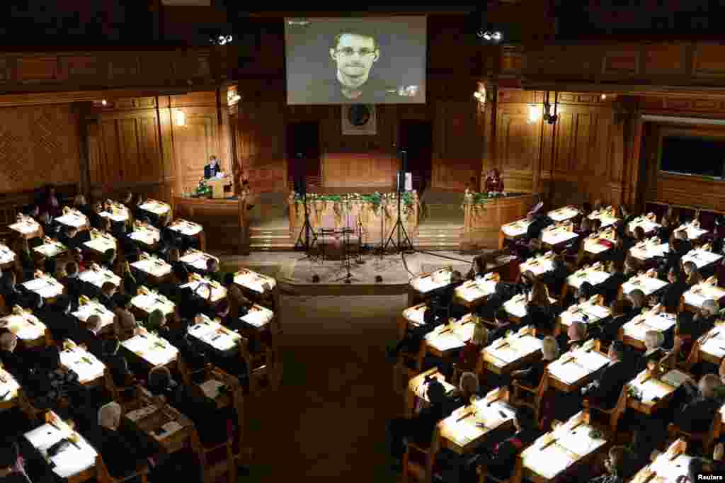 Swedish Member of Parliament Barbro Westerholm (L) speaks to former U.S. NSA contractor Edward Snowden, shown on a livestream from Moscow, during the Right Livelihood Award ceremony at the second chamber hall at the Swedish Parliament in Stockholm. Snowden was awarded the Right Livelihood Honorary Award for &quot;his courage and skill in revealing the unprecedented extent of state surveillance violating basic democratic processes and constitutional rights.&quot;