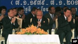 Cambodian Prime Minister Hun Sen, right, prays with President of the Cambodian National Assembly Heng Samrin, left, and Senate President Chea Sim, center, during a celebration marking the 34th anniversary of the 1979 downfall of the Khmer Rouge regime, in Phnom Penh, Cambodia, Monday, Jan. 7, 2013. (AP Photo/Heng Sinith)