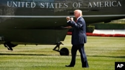 FILE - President Donald Trump walks on the South Lawn of the White House in Washington to board Marine One helicopter for a short trip to Andrews Air Force Base, Maryland, en route to Bedminster, N.J., for vacation, Aug. 4, 2017.