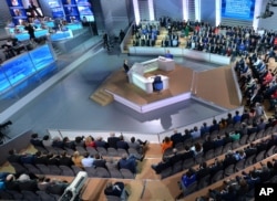 Russian President Vladimir Putin, center, speaks during his marathon call-in TV show in Moscow, April 14, 2016.