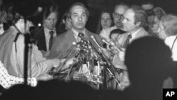 White House Press Secretary Ron Nessen reads his earlier statement on Cambodia outside the White House in Washington, Wednesday, May 14, 1975. Nessen announced that Marines had stormed aboard the U.S. merchant ship Mayaguez held captive by the Cambodians.