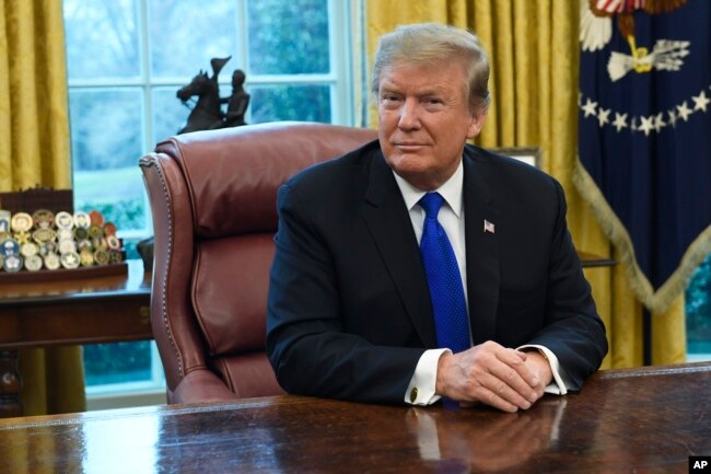 FILE - President Donald Trump listens during his meeting with Chinese Vice Premier Liu He in the Oval Office of the White House in Washington, Feb. 22, 2019.
