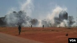 Police use teargas in an attempt to disperse protesters.