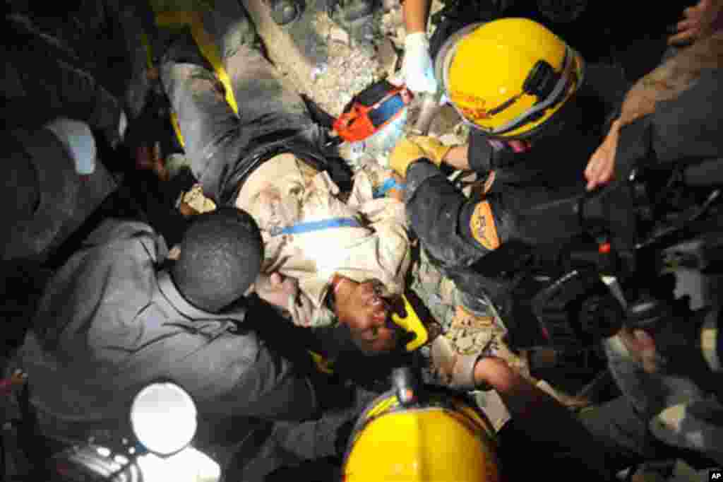 Members of the Los Angeles County Fire Department Search and Rescue Team rescue a Haitian woman from a collapsed building in downtown Port-au-Prince, 17 Jan 2010 - U.S. Navy Petty Officer 2nd Class Justin Stumberg