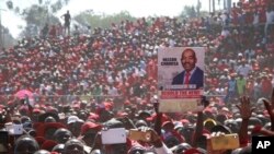 Movement for Democratic Change (MDC) supporters hold a poster of leader Nelson Chamisa during the party's 19th-anniversary celebrations in Harare, Zimbabwe, Saturday, Oct. 27, 2018.