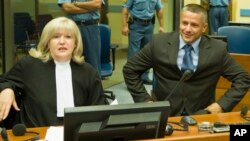 FILE- Naser Oric (R) is seen with his lawyer during his trial in The Hague, Netherlands, July 3, 2008.