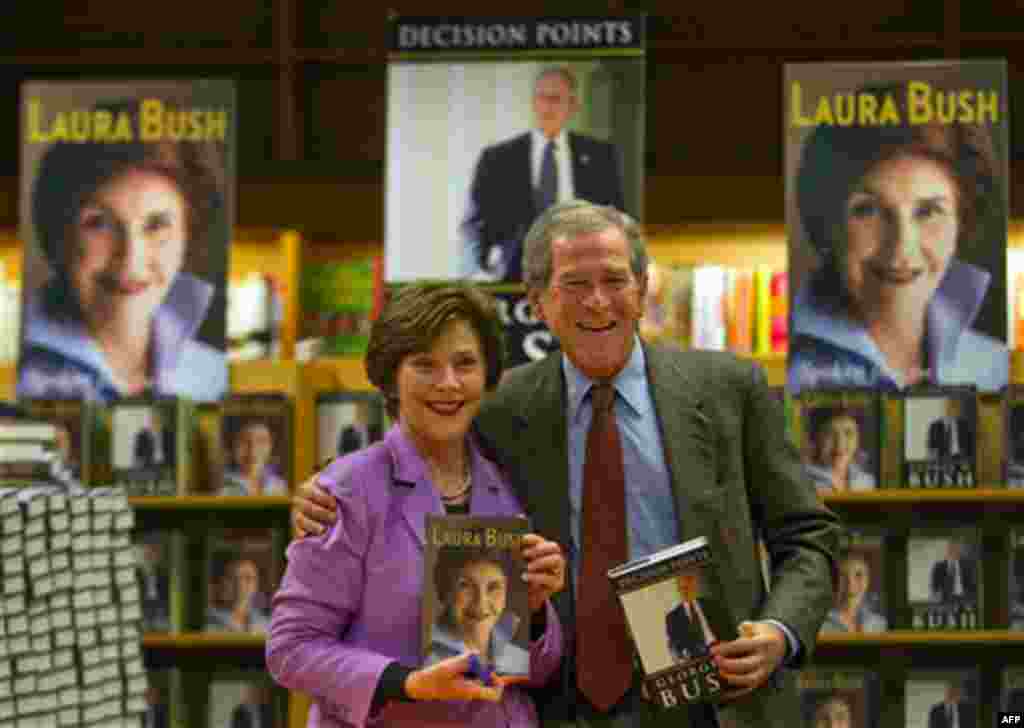 Former President George W. Bush, right, and his wife Laura appear together to sign their respective books, 'Decision Points' by him, ,and "Spoken From the Heart'" by her, Thursday, Dec. 16 in Atlanta.