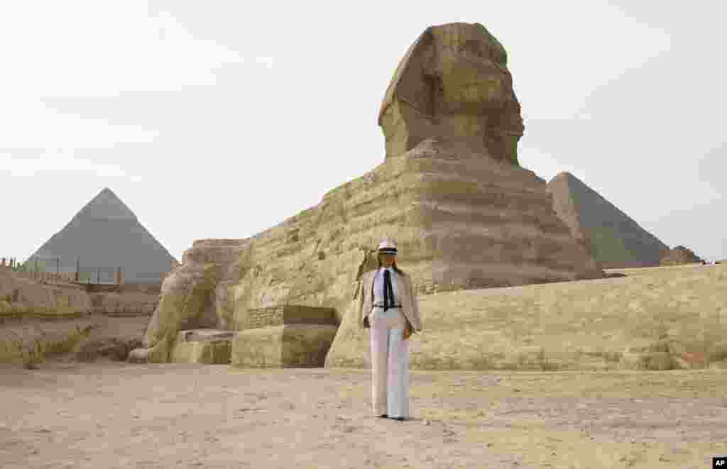 First lady Melania Trump visits the ancient statue of Sphinx, with the body of a lion and a human head, at the historic site of Giza Pyramids in Giza, near Cairo, Egypt, Oct. 6, 2018. 