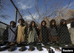 FILE - Pakistani Taliban fighters, who were arrested by Afghan border police, stand during a presentation of seized weapons and equipment to the media in Kabul, Afghanistan on January 5, 2016.