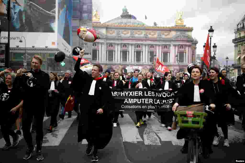 French lawyers on strike take part in a protest against the government&#39;s retirement reform bill, in front of the Opera Garnier in Paris.