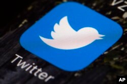 FILE - This April 26, 2017, photo shows the Twitter app icon on a mobile phone in Philadelphia. According to a study released Jan. 24, 2019, a tiny fraction of Twitter users spread the vast majority of fake news in 2016, with conservatives and older people sharing misinformation more.