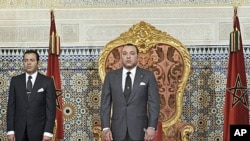 Morocco's King Mohammed (R), shown here as he prepared to address the nation on June 17, 2011, is under pressure to guarantee a greater separation of power in the kingdom
