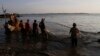 FILE - Ethnic Vietnamese fishermen collect catches from the Mekong river near Arey Ksat village at the outskirt of Phnom Penh, Cambodia, Feb. 6, 2014.