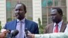 FILE - Lul Ruai Koang (L), the military spokesperson for the Sudan People's Liberation Army (SPLA) and James Gatdet Dak, spokesperson for opposition leader Riek Machar (R), give a statement to the press in Addis Ababa on May 9, 2014. 