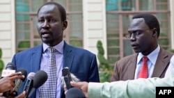 Lul Ruai Koang (left), ex-spokesman for Riek Machar's rebel group, returned to Juba after breaking with the Sudan People's Liberation Movement in Opposition (SPLM-IO). 