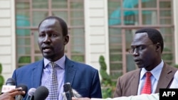 Lul Ruai Koang (L), the military spokesman for opposition forces in South Sudan, and James Gatdet Dak, spokesman for opposition leader Riek Machar, speak to reporters in Addis Ababa on May 9, 2014.