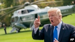 President Donald Trump speaks to reporters before boarding Marine One on the South Lawn of the White House in Washington, Oct. 25, 2017, for a short trip to Andrews Air Force Base, Maryland, and then on to Dallas. 