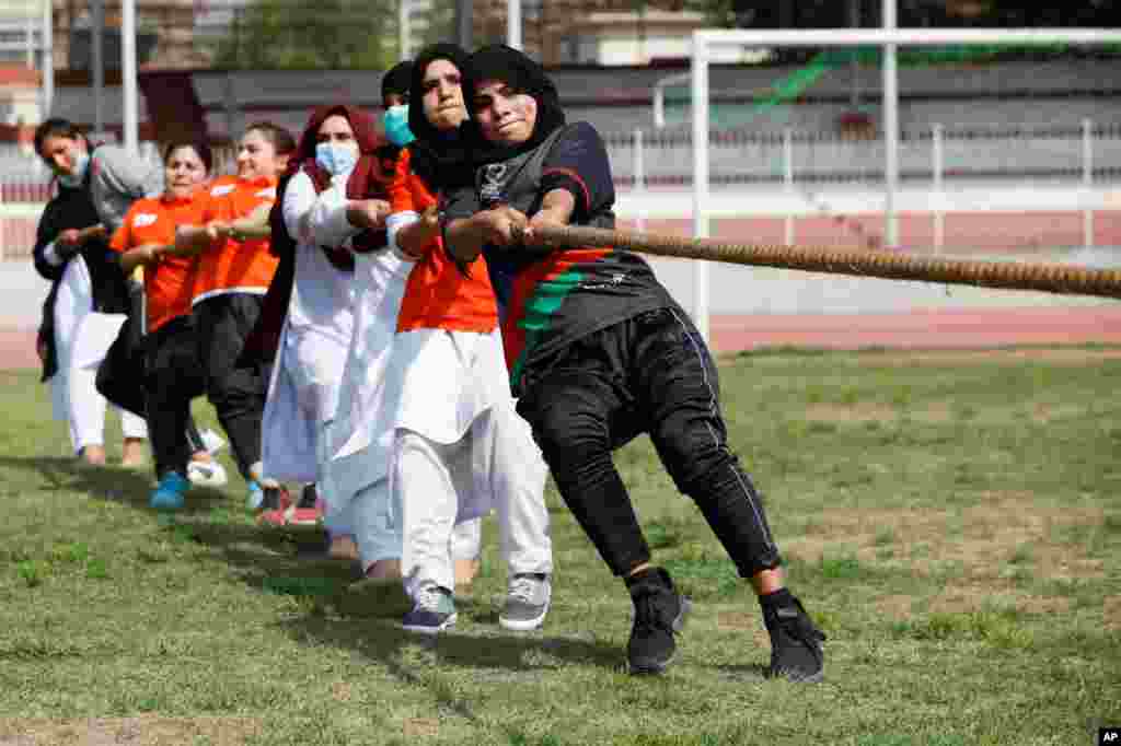 Women participants in a tug of war contest on the International Women&#39;s Day celebrations in Peshawar, Pakistan.