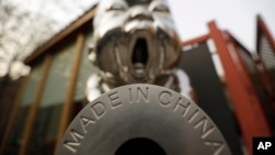 FILE - A sculpture is displayed with the phrase "Made in China," at the 798 Art District in Beijing, China, Nov. 21, 2012.
