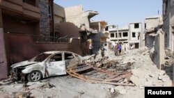 People gather at the site of a car bomb attack in Kirkuk, 250 kilometers north of Baghdad, Iraq, Aug. 11, 2013.