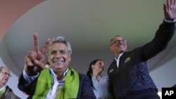 Alianza PAIS's presidential candidate Lenin Moreno, left, and his running mate Jorge Glas smile at the end of the day of the presidential election, in Quito, Ecuador, April 2, 2017.