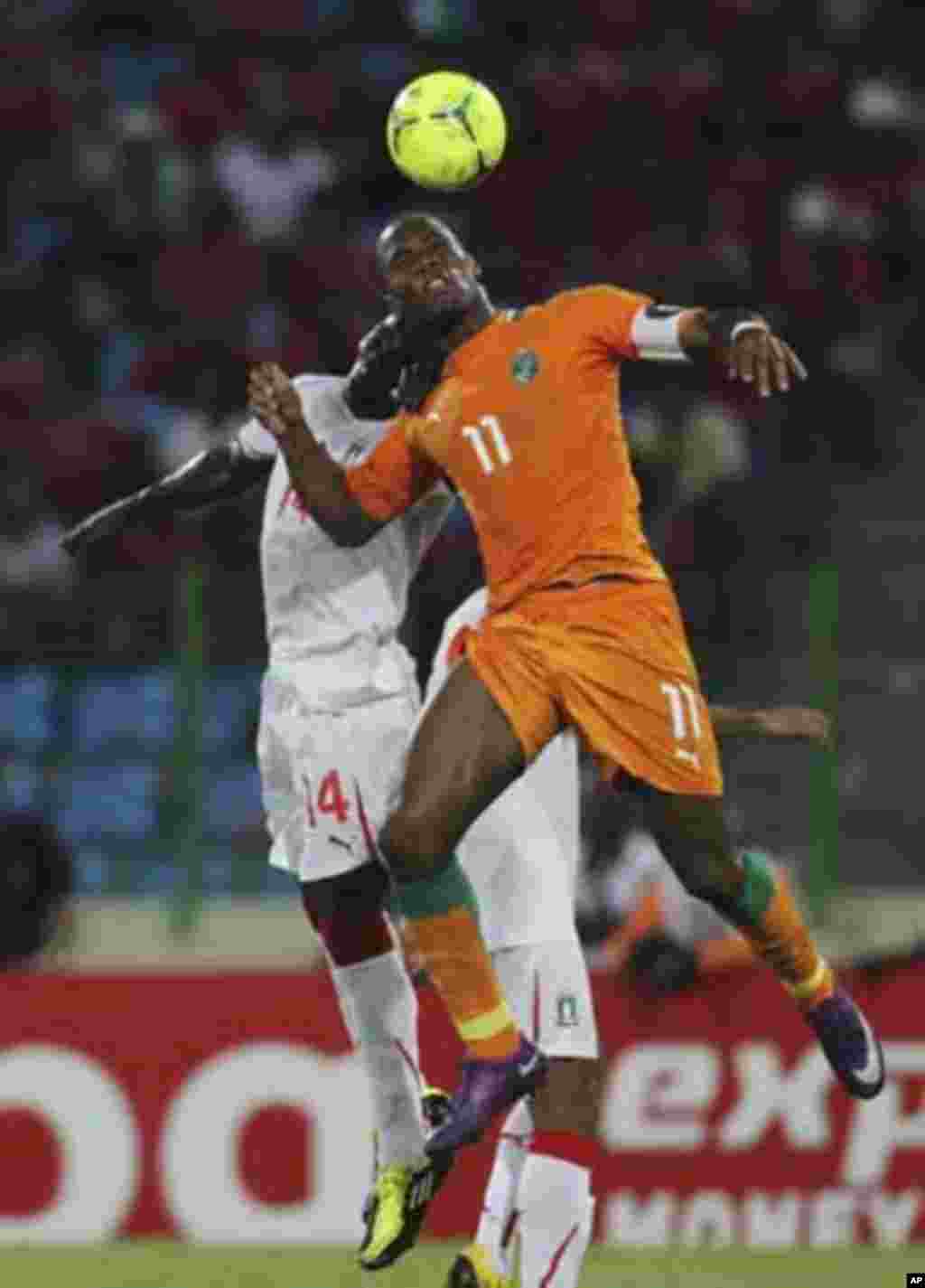 Didier Drogba (R) of Ivory Coast fights for the ball with Ben Konate of Equatorial Guinea during their quarter-final match at the African Nations Cup soccer tournament in Malabo February 4, 2012.