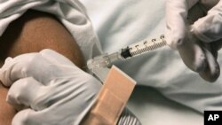 Sherry Webb is given an injection for pain relief by a nurse at the Sickle Cell Center in Truman Medical Center, Wednesday, March 7, 2007 in Kansas City, Mo. Pain management is vital in the care of patients suffering from Sickle Cell disease. 