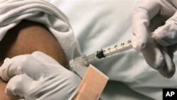 FILE - Patient is given injection for pain relief by nurse at the Sickle Cell Center in Truman Medical Center, Kansas City, Missouri.