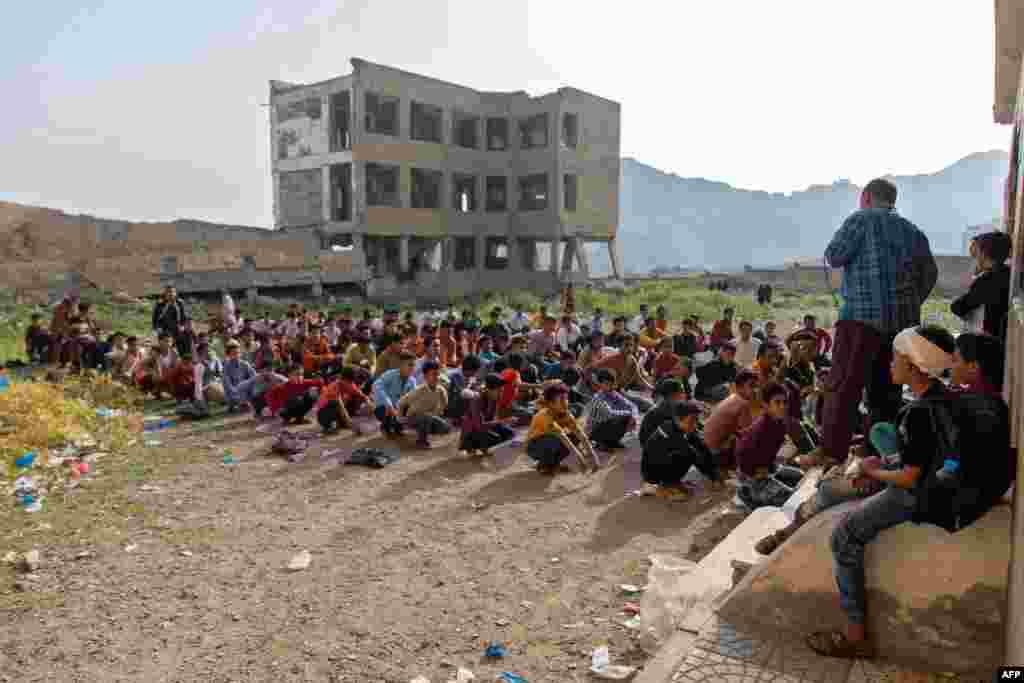 Yemeni students attend class in their destroyed school compound on the first day of the new academic year in the country&#39;s third-city of Taez.