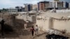 Afghan refugee children play near their temporary housing on the outskirts of Kabul, Afghanistan, June 30, 2013.