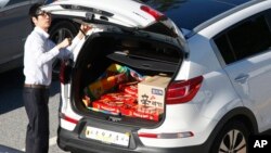 South Korean businessman with trunkload of Choco Pie snacks and noodles checks car before heading to the Kaesong Industrial Complex just north of the demilitarized zone separating the two Koreas, Sept. 16, 2013.