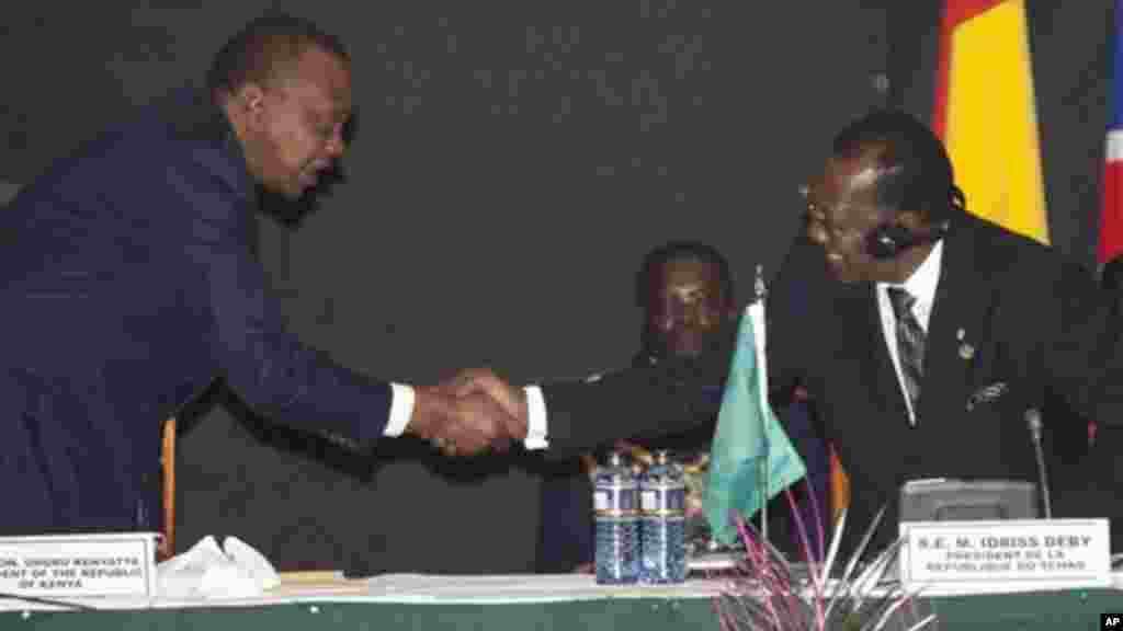 President of Kenya, Uhuru Kenyatta, left, shake hands with President of Chad, Idriss Deby, during the AU Summit, Sept. 2, 2014, in Nairobi, Kenya.