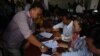 Opposition supporters thumbprint a petition to King Norodom Sihamoni at the Cambodia National Rescue Party's headquarters in Phnom Penh, Thursday, June 2, 2016.