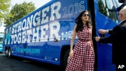 FILE - Huma Abedin, center, an aide to Democratic presidential candidate Hillary Clinton, gets off a campaign bus for Democratic presidential candidate Hillary Clinton and Democratic Vice Presidential candidate, Sen. Tim Kaine, D-Va., July 29, 2016.