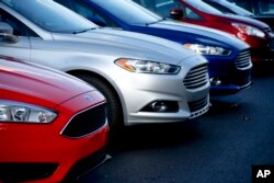 FILE - Ford Fusions are for sale on the lot at Butler County Ford in Butler, Pa., in November 2015. Ford Motor Co. has built the midsize Fusion sedan at its plant in Hermosillo, Mexico, since its introduction in 2005.