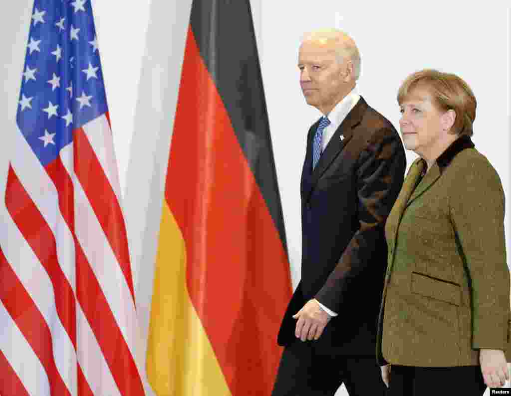 German Chancellor Angela Merkel and U.S. Vice President Joe Biden arrive to make a statement to the media before talks in Berlin February 1, 2013. REUTERS/Tobias Schwarz (GERMANY - Tags: POLITICS) - RTR3D885