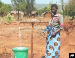 Woman at water tap