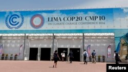 People walk at the venue of the U.N. Climate Change Conference COP 20 in Lima, Peru, Dec. 4, 2014.