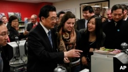 FILE - Chinese President Hu Jintao visits the The Confucius Institute which is housed at Walter Payton College Preparatory High School in Chicago, Friday, Jan. 21, 2011.