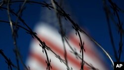 FILE - Concertina wire lines the top of a wall at the San Ysidro port of entry in San Diego, California, on the U.S. border with Mexico, Nov. 16, 2018.