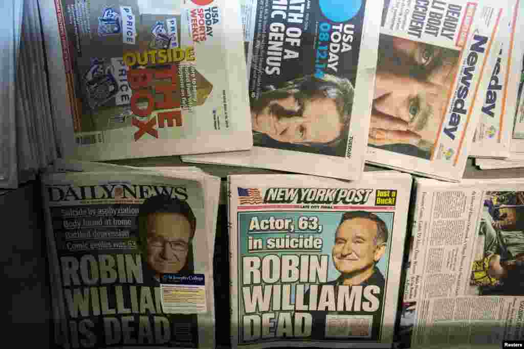 Newspapers announcing the death of comedian Robin Williams are stacked on a newsstand in New York, Aug. 12, 2014.