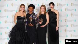 Rungano Nyoni and Emily Morgan hold their awards for an Outstanding Debut by A British Writer, Director or Producer for 'I Am Not A Witch' with citation readers Lily James and Gemma Arterton at the British Academy of Film and Television Awards (BAFTA) at the Royal Albert Hall in London, Britain, Feb. 18, 2018. 