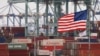 FILE - Chinese shipping containers are stored beside a U.S. flag after they were unloaded at the Port of Los Angeles in Long Beach, California, on May 14, 2019. 