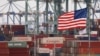 Chinese shipping containers are stored beside a U.S. flag after they were unloaded at the Port of Los Angeles in Long Beach, California, May 14, 2019. 