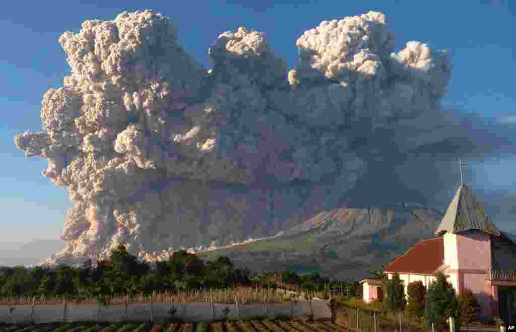Mount Sinabung spews volcanic material during an eruption in Karo, North Sumatra, Indonesia.