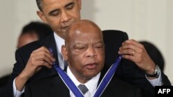 President Barack Obama awards the Presidential Medal of Freedom to Congressman and civil rights leader, John Lewis at a White House ceremony in 2011. (Photo by ALEX WONG / AFP)