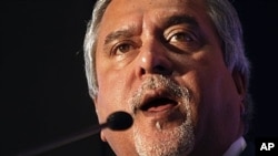 FILE - Vijay Mallya peaks during a media conference in Mumbai, India, Nov. 15, 2011. Finance Minister Arun Jaitley says India will begin extradition proceedings from Britain once official charges are filed against the businessman. 