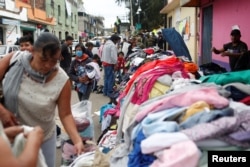 Residents look for donated clothes at a collection center after the earthquake in Xochimilco, on the outskirts of Mexico City, Mexico, Sept. 25, 2017.